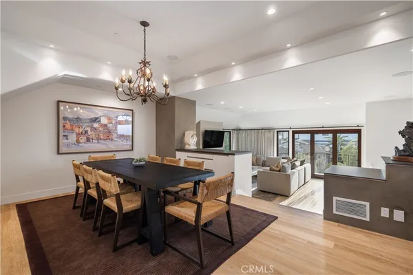 a view of a dining room with furniture wooden floor and chandelier