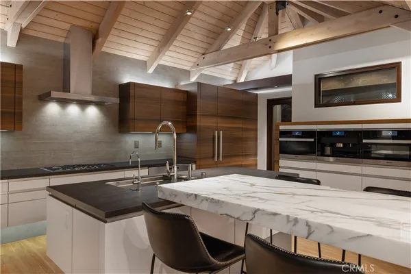 a kitchen with stainless steel appliances granite countertop a sink and a stove