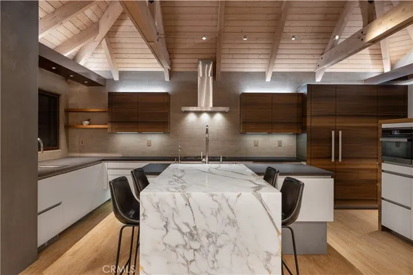 a kitchen with a table chairs and a refrigerator