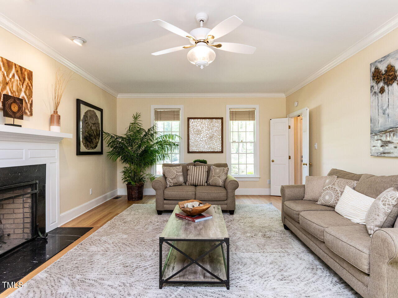 315 King George Loop Cary, NC 27511 - Photo 12 of 39 a living room with furniture a large window and a fireplace