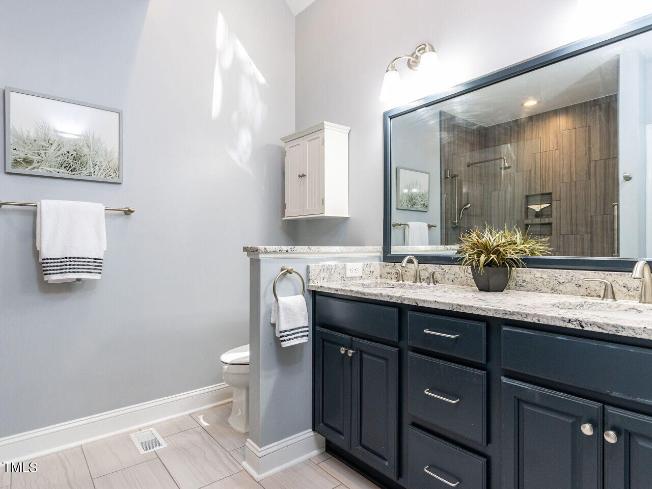 315 King George Loop Cary, NC 27511 - Photo 18 of 39 a bathroom with a double vanity sink and a mirror