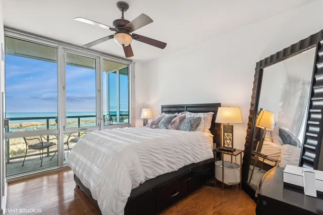 a bedroom with a bed and a chandelier