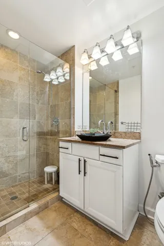 a bathroom with a sink mirror and a shower