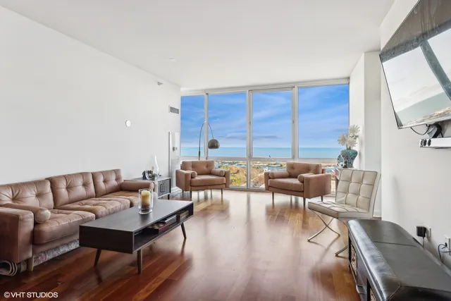 a living room with furniture wooden floor and a flat screen tv