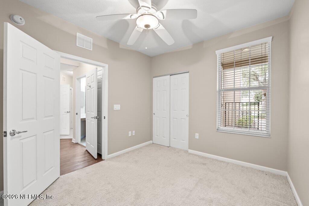 8757 Little Swift Circle, Unit 22F Jacksonville, FL 32256 - Photo 15 of 46 a view of a livingroom with a chandelier fan and windows