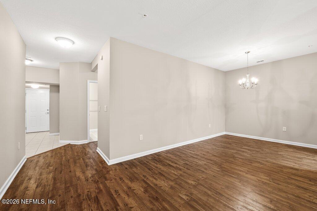 8757 Little Swift Circle, Unit 22F Jacksonville, FL 32256 - Photo 16 of 46 a view of empty room with wooden floor