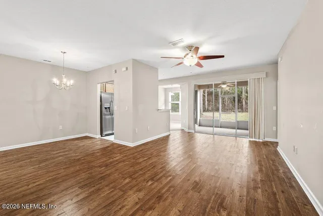 a living room with furniture a flat screen tv and a large window