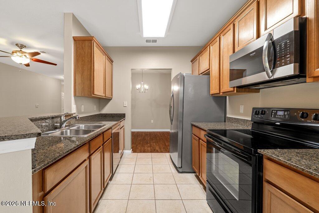 8757 Little Swift Circle, Unit 22F Jacksonville, FL 32256 - Photo 20 of 46 a kitchen with stainless steel appliances granite countertop a stove and a sink
