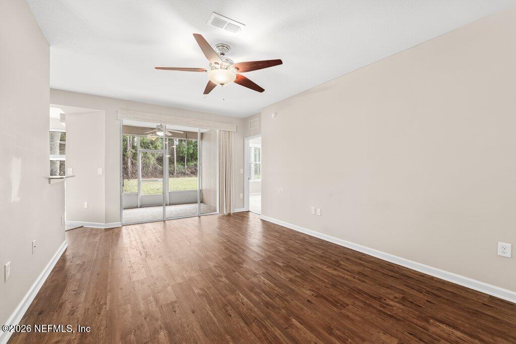 8757 Little Swift Circle, Unit 22F Jacksonville, FL 32256 - Photo 25 of 46 an empty room with wooden floor fan and windows