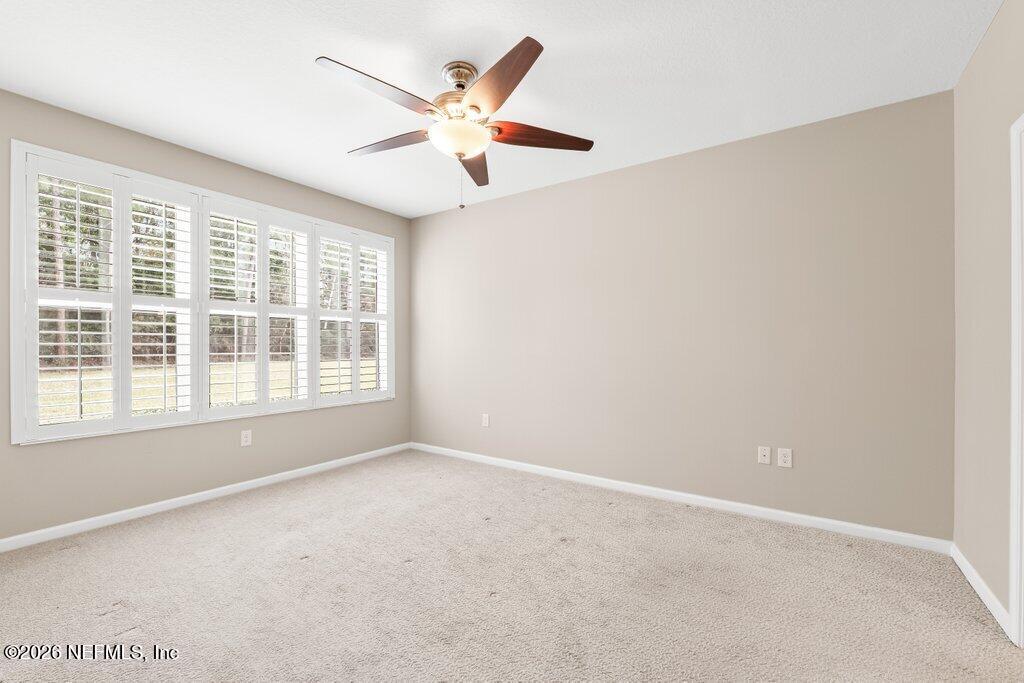 8757 Little Swift Circle, Unit 22F Jacksonville, FL 32256 - Photo 27 of 46 an empty room with windows and fan