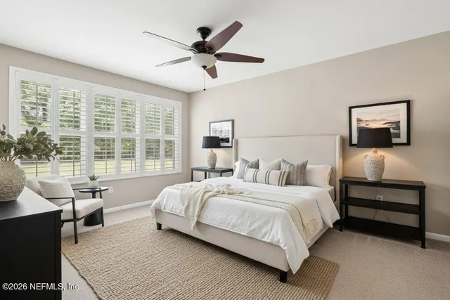 en empty room with windows and fan