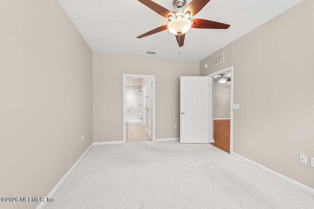8757 Little Swift Circle, Unit 22F Jacksonville, FL 32256 - Photo 29 of 46 en empty room with windows and fan