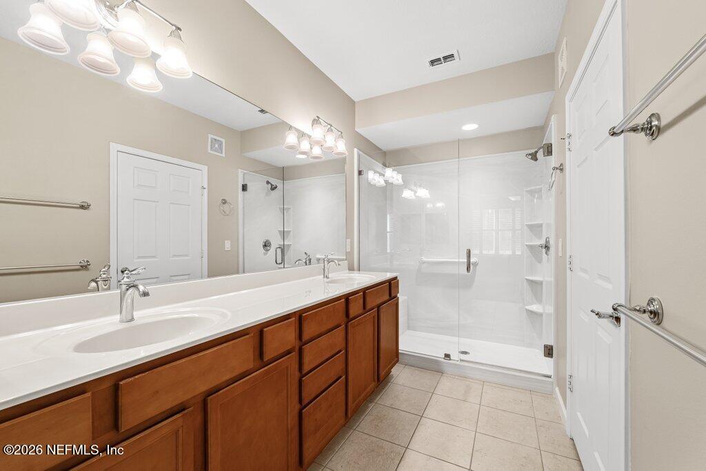 8757 Little Swift Circle, Unit 22F Jacksonville, FL 32256 - Photo 30 of 46 a bathroom with a double vanity sink mirror double and shower