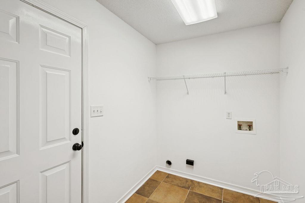 5661 Berrybrook Circle Pace, FL 32571 - Photo 11 of 21 a view of a room with racks on the wall