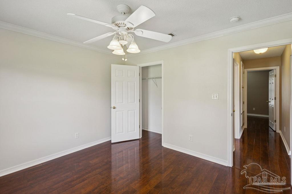 5661 Berrybrook Circle Pace, FL 32571 - Photo 12 of 21 a view of an empty room with wooden floor