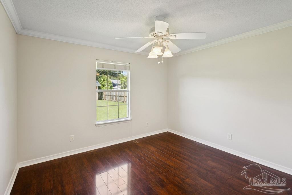 5661 Berrybrook Circle Pace, FL 32571 - Photo 13 of 21 wooden floor in an empty room with a window