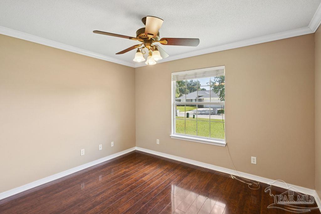 5661 Berrybrook Circle Pace, FL 32571 - Photo 15 of 21 a view of an empty room with wooden floor and a window