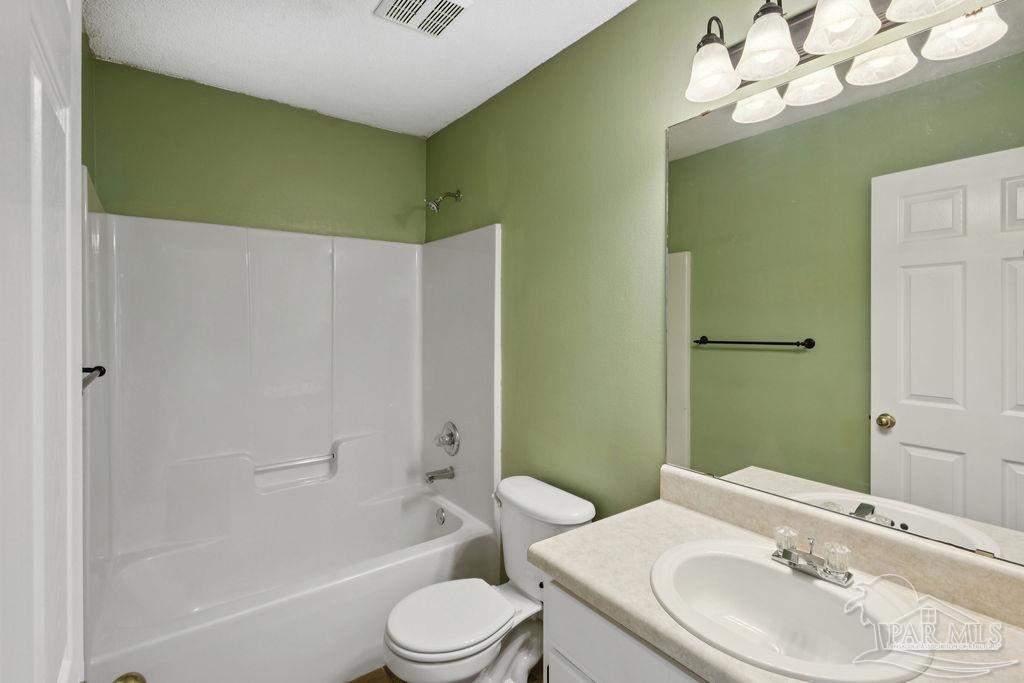 5661 Berrybrook Circle Pace, FL 32571 - Photo 16 of 21 a bathroom with a sink toilet and shower