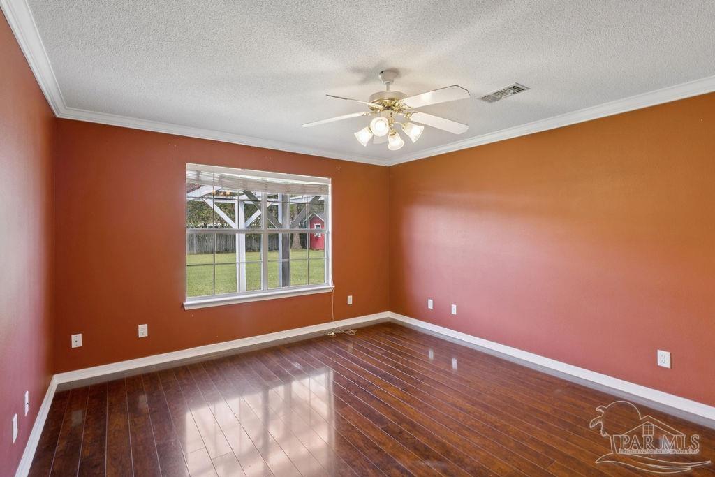 5661 Berrybrook Circle Pace, FL 32571 - Photo 17 of 21 a view of an empty room with a window and wooden floor