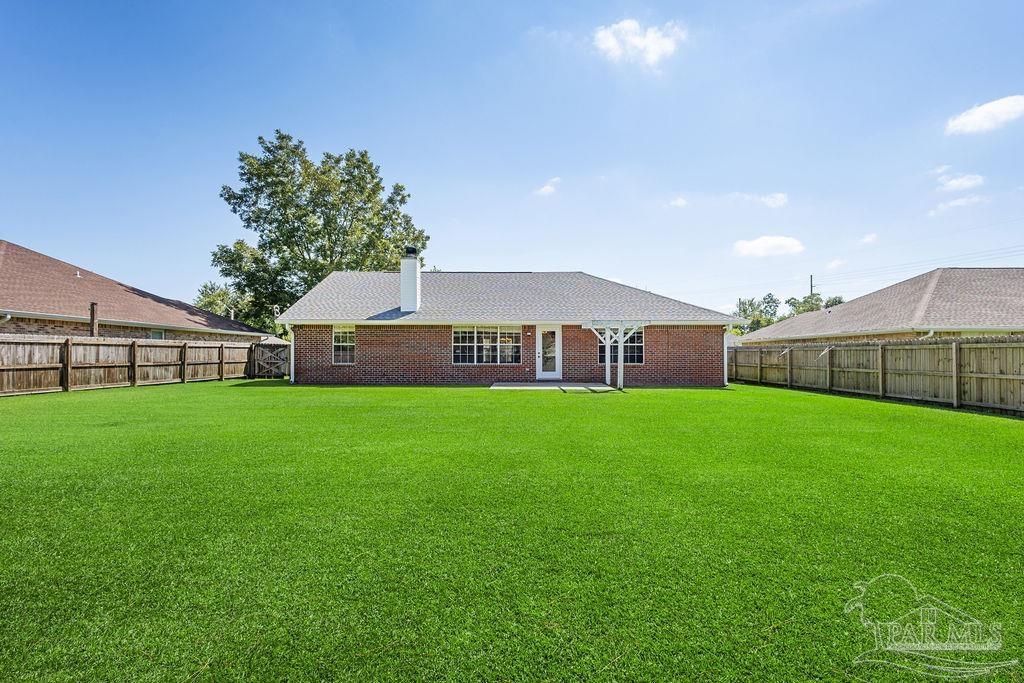5661 Berrybrook Circle Pace, FL 32571 - Photo 2 of 21 a view of a big house in a big yard with large trees