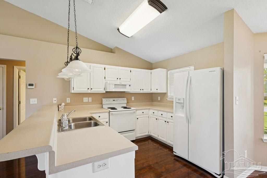5661 Berrybrook Circle Pace, FL 32571 - Photo 5 of 21 a kitchen with cabinets appliances wooden floor and a view of living room