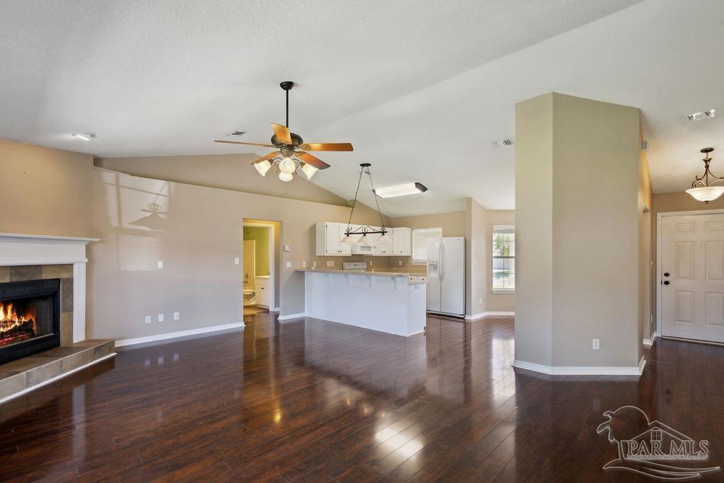 5661 Berrybrook Circle Pace, FL 32571 - Photo 6 of 21 a view of a livingroom with furniture wooden floor fireplace and a window
