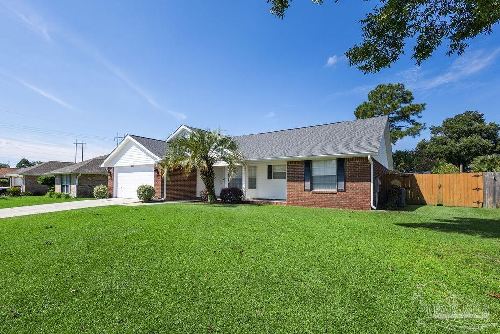 5661 Berrybrook Circle Pace, FL 32571 - Photo 8 of 21 a front view of a house with a yard and garage