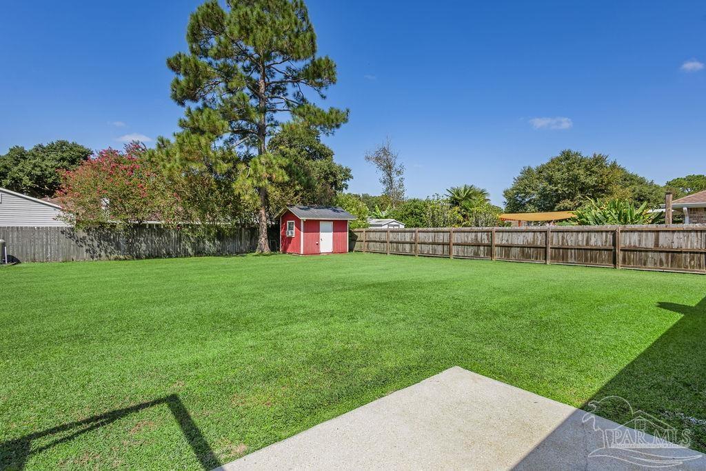 5661 Berrybrook Circle Pace, FL 32571 - Photo 9 of 21 a view of yard with grass and trees