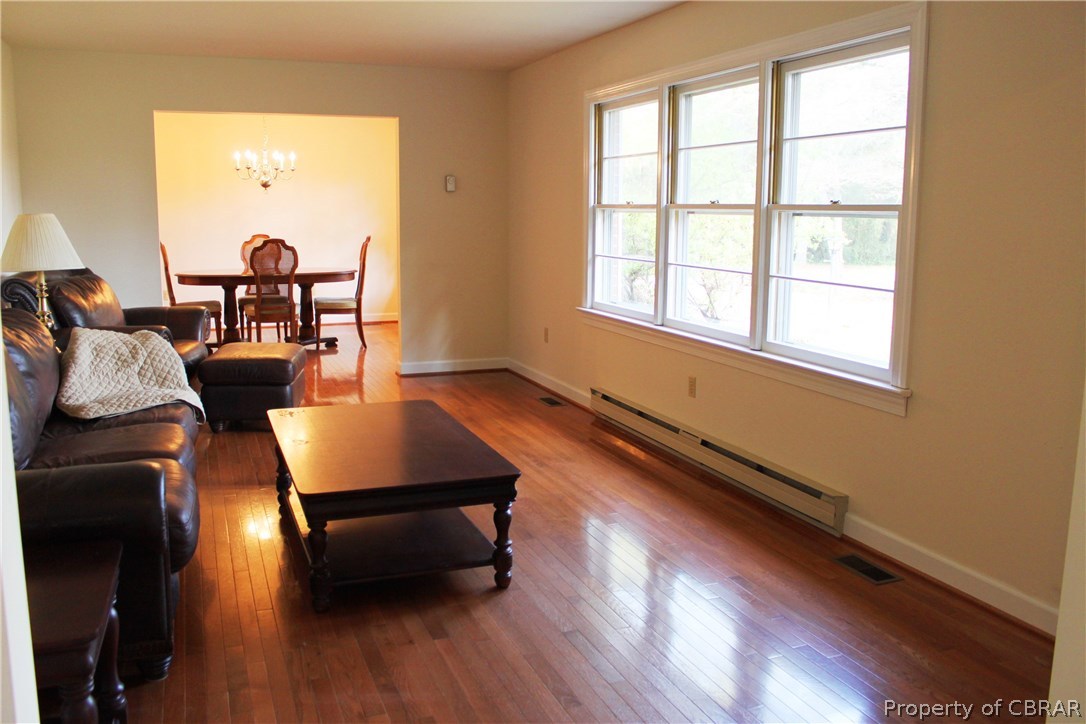 7449 Joseph Lewis Road Hayes, VA 23072 - Photo 4 of 32 Living Room with wood flooring and plentiful natural light.