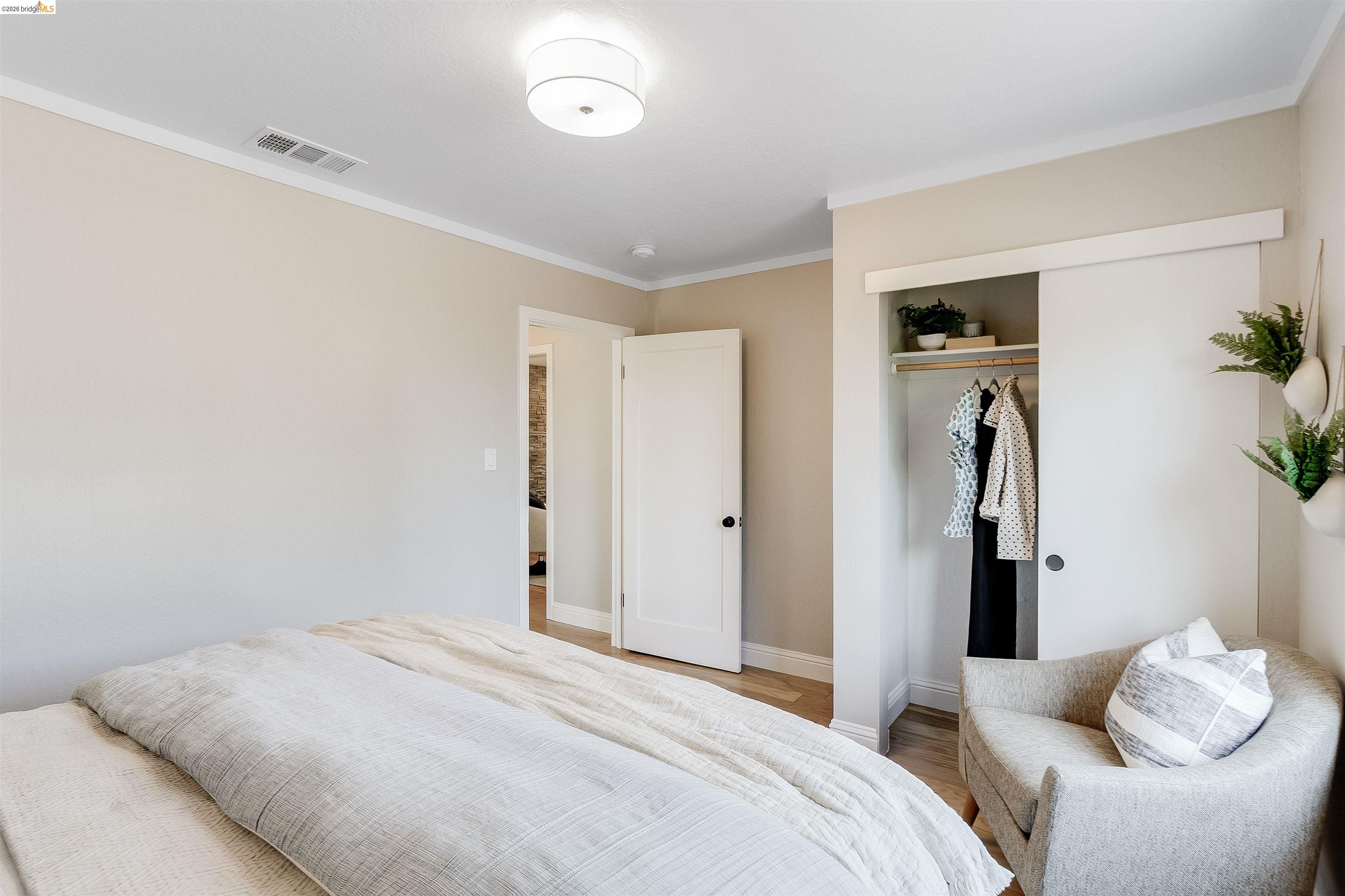346 Valley View Road Pleasant Hill, CA 94523 - Photo 29 of 57 Bedroom featuring light wood-finish flooring, a flush-mount ceiling light fixture, and white crown molding