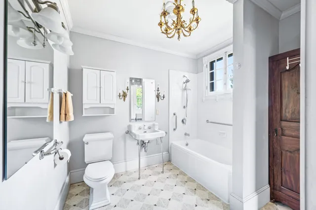 a view of an empty room with wooden floor and closet