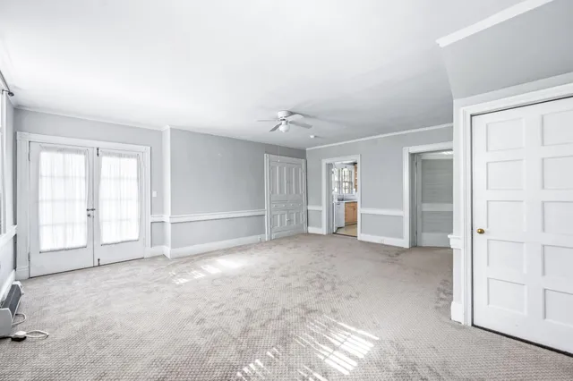 a kitchen with granite countertop a stove a sink and a refrigerator