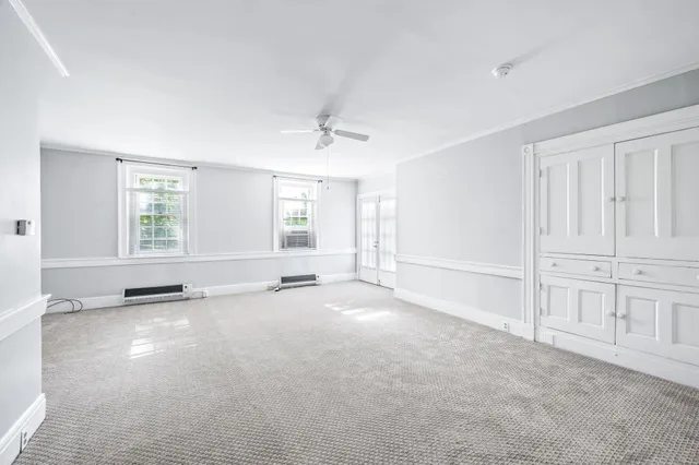 an empty room with windows and closet