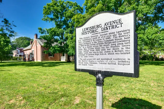 a view of a house with a small yard and a large window