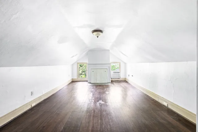 a view of a house with a big yard plants and large trees
