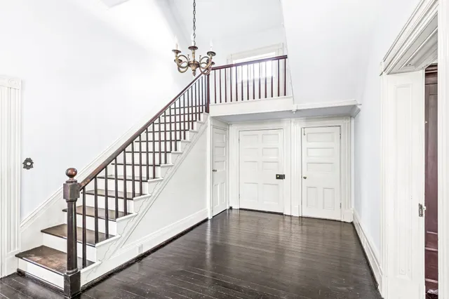 a living room with wooden floors and fireplace