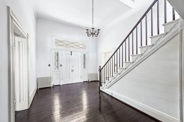 a view of an empty room with window wooden floor and closet