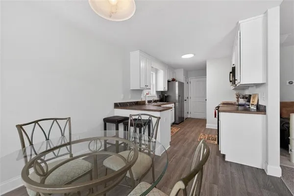 a kitchen with a table chairs a sink and a stove