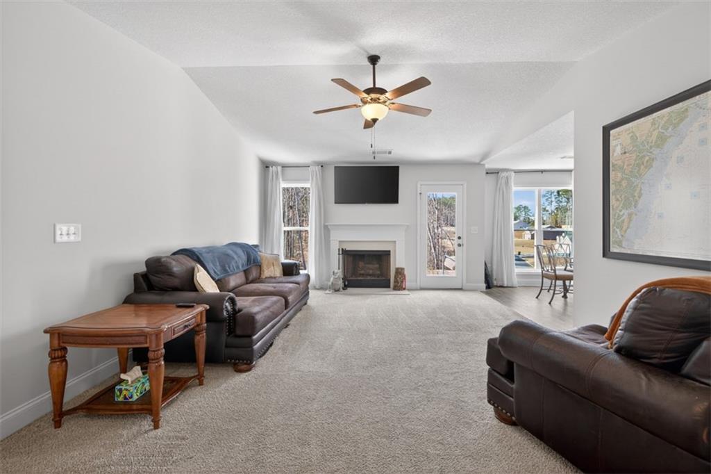 142 Rolling Wds Lane Colbert, GA 30628 - Photo 2 of 34 a living room with furniture and a fireplace