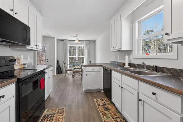 a kitchen with a sink stove and cabinets