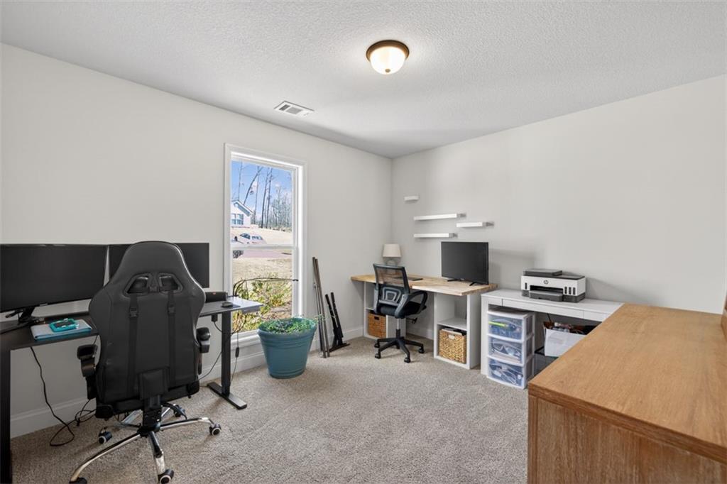 142 Rolling Wds Lane Colbert, GA 30628 - Photo 27 of 34 a view of a workspace with furniture and a window