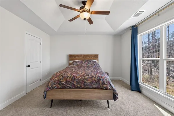 a bedroom with a bed and window