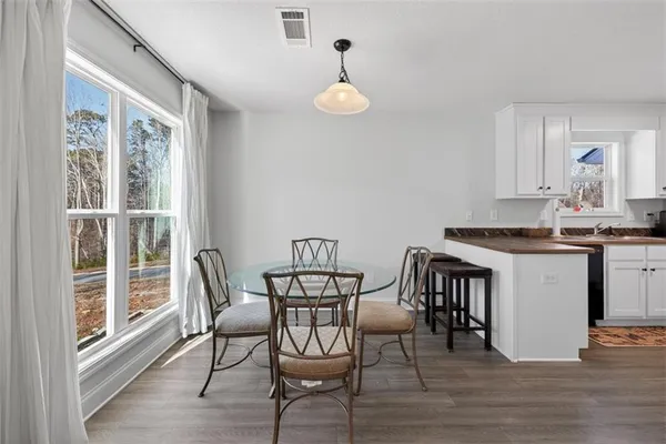 a view of a dining room with furniture and wooden floor