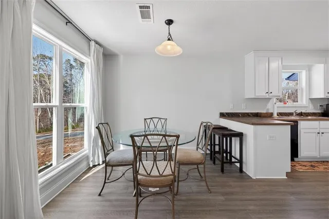 a view of a dining room with furniture and wooden floor