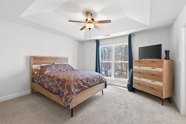 a bedroom with a bed and a flat tv screen