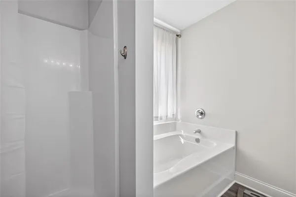 a bathroom with a bathtub and shower