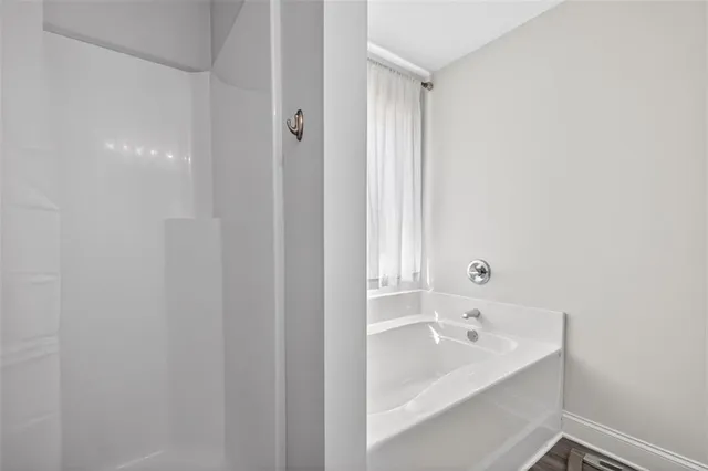 a bathroom with a bathtub and shower