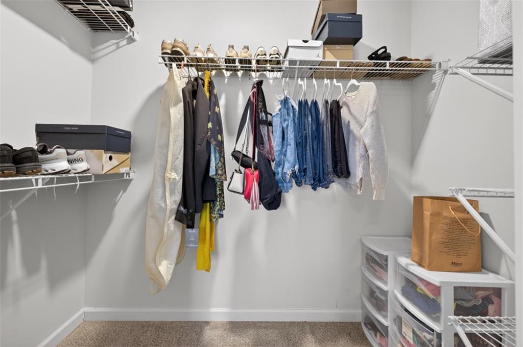 142 Rolling Wds Lane Colbert, GA 30628 - Photo 8 of 34 a view of walk in closet with clothes and shoes