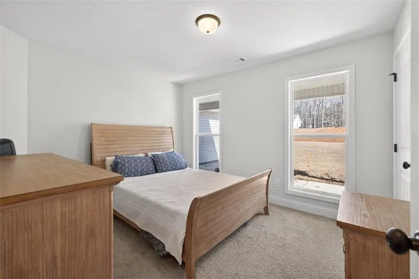 a bedroom with a bed and window