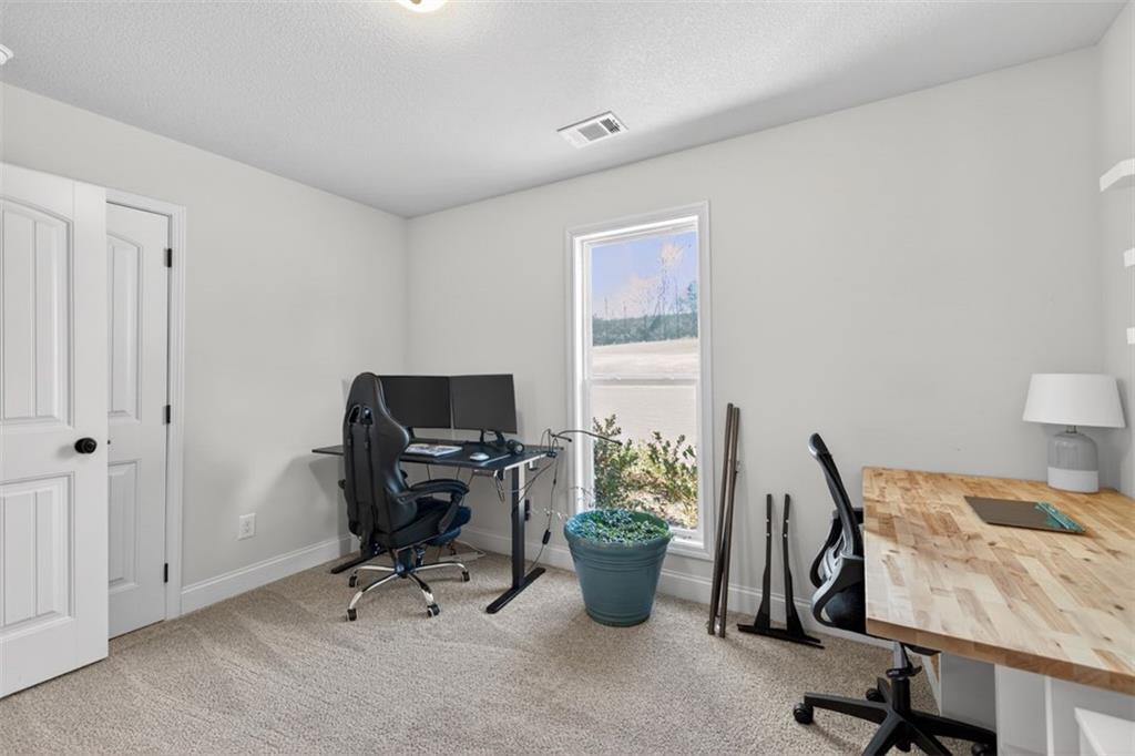 142 Rolling Wds Lane Colbert, GA 30628 - Photo 10 of 34 a view of a workspace with furniture and a window